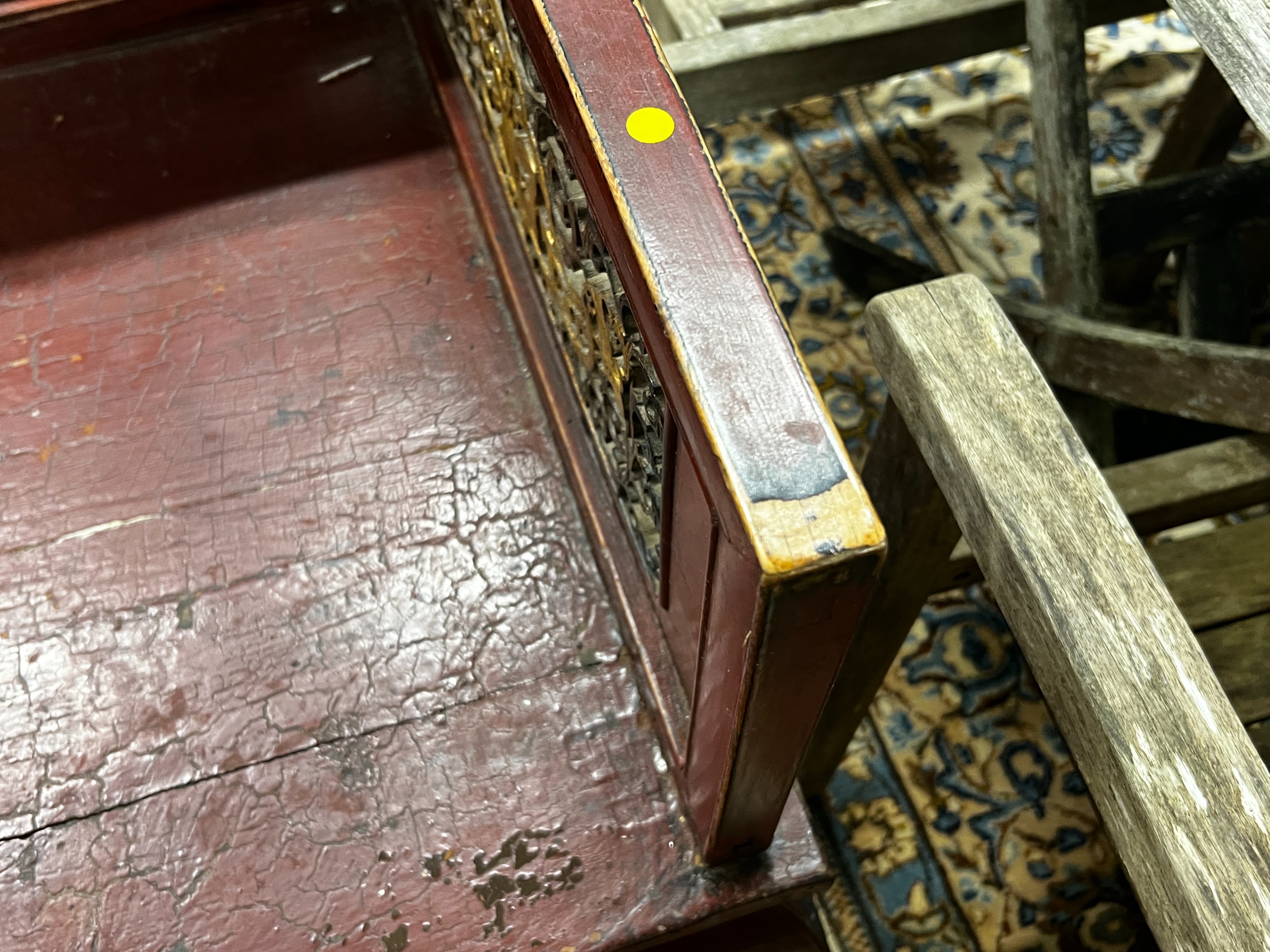 A Chinese scarlet lacquer parcel gilt bench, length 125cm, depth 70cm, height 97cm